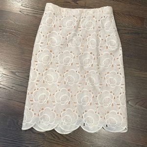 Jcrew white skirt with scalloped hemline and attached nude slip.